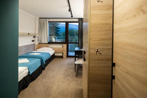 Postel nebo postele na pokoji v ubytování Hotel Halo Szczyrk
