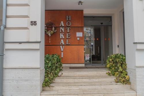 a entrance to a building with a sign on it at Hotel Ankavi in Szeged