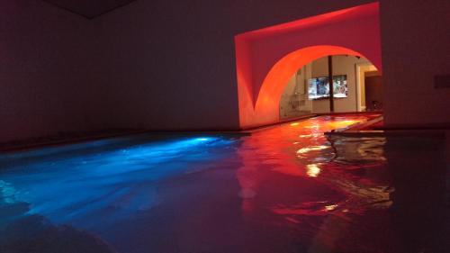 シラクーサにあるMedusa Rooms & SPAの赤と青の灯水プール