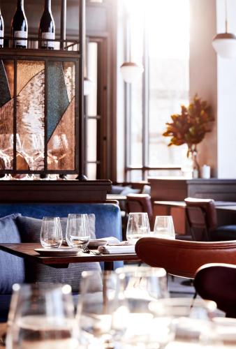 a restaurant with tables and chairs with wine glasses at The Blake Hotel in New Haven