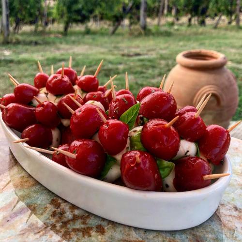 a bowl of red cherries sitting on a table at Podere Bellavista in San Gimignano