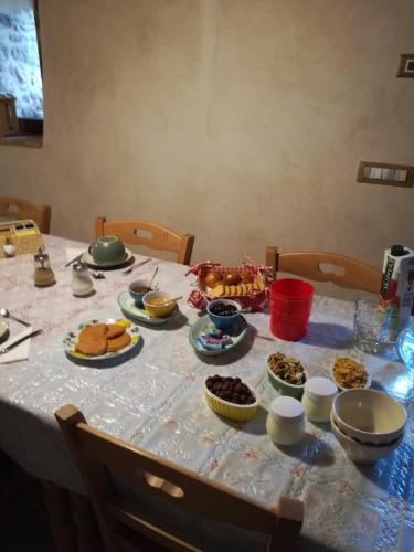a table with plates of food on top of it at Agriturismo il posto delle fragole in San Giovanni Bianco