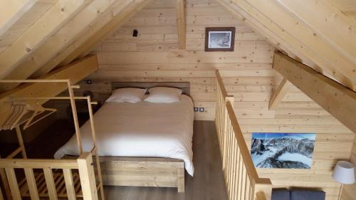 - un lit dans le grenier d'une cabane en rondins dans l'établissement Le chalet des Pierres, à Viuz-en-Sallaz