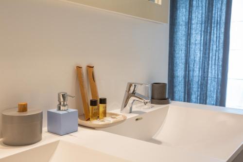 a bathroom with a sink and a mirror at Chambre d'Hôtes Etchebri in Anglet