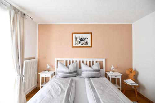 a bedroom with a large white bed with white pillows at Haus Vollmeier in Debant