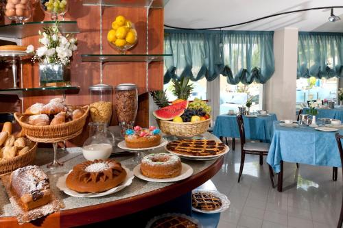 un tavolo pieno di diversi tipi di pane e dolci di Suite Apartment Exclusive a Bellaria-Igea Marina