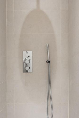 a shower in a bathroom with a picture on the wall at Tadmor Townhouse in London