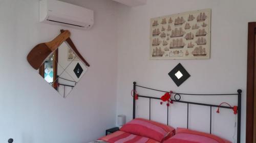 a bedroom with a bed and a mirror on the wall at Casa Panorama Amalfi Coast in Vietri sul Mare