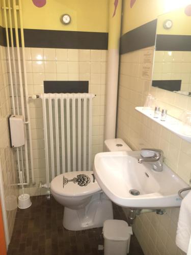 a bathroom with a sink and a toilet at Hotel Alain et Martine in Viviers-du-Lac