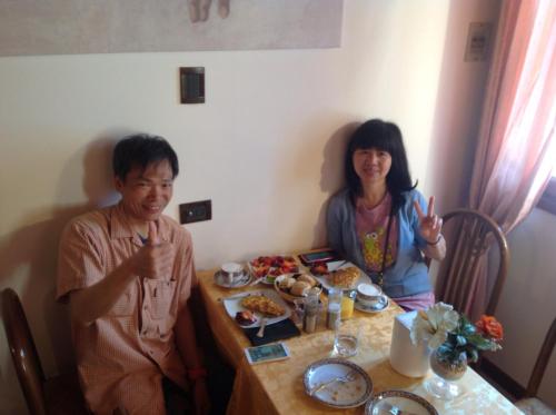 a man and a woman sitting at a table eating food at Ca'Nova Alloggi in Campalto