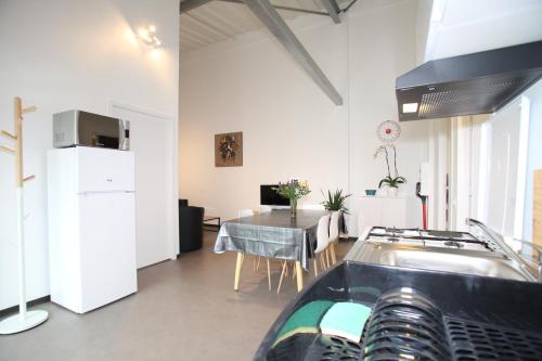 a kitchen and dining room with a sink and a table at Résidence Beauvoir le Mont-Saint-Michel (9 gîtes de 2 à 5 personnes) in Beauvoir
