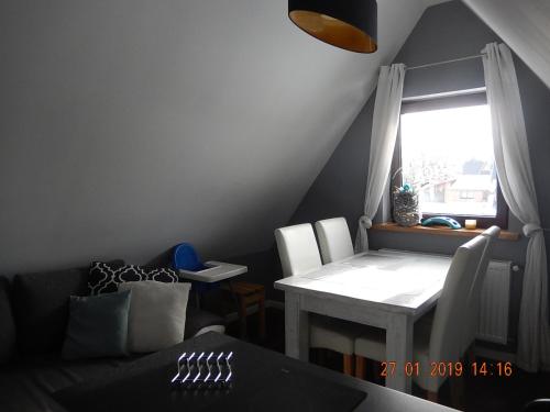 a living room with a table and a window at U Hanki in Biały Dunajec