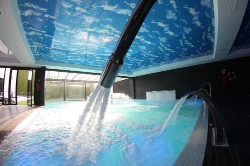 a swimming pool with a water fountain at Hotel & Thalasso Villa Antilla - Habitaciones con Terraza - Thalasso incluida in Orio