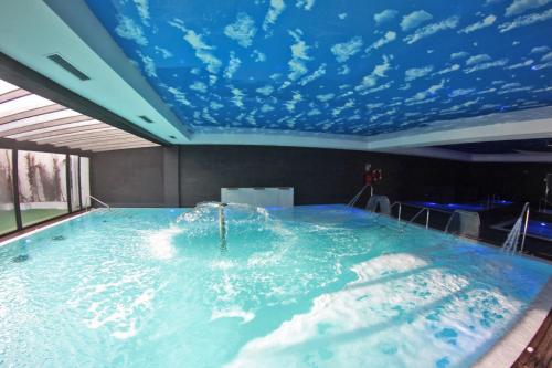 a large swimming pool with a blue ceiling at Hotel & Thalasso Villa Antilla - Habitaciones con Terraza - Thalasso incluida in Orio