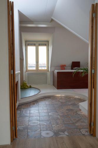 an attic room with a tile floor and a window at El Puerto Bed and Breakfast in Hoorn