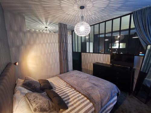 una camera da letto con un letto con cuscini sopra di Au Saint Martin a Cholet