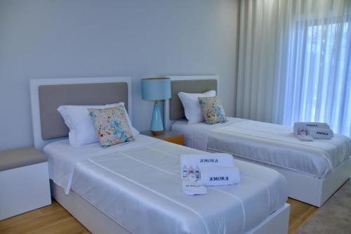 Säng eller sängar i ett rum på Amora Villa Sacha
