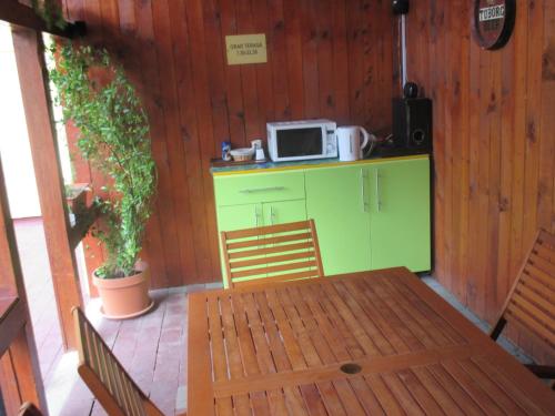 a kitchen with a table and a microwave on a counter at Pensiunea Boema in Cluj-Napoca