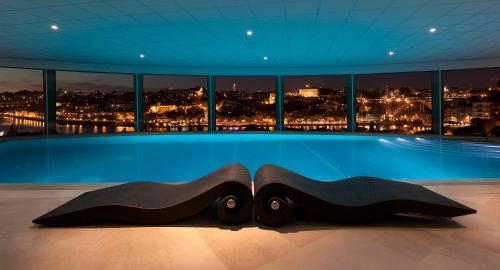 a swimming pool with a view of a city at The Yeatman in Vila Nova de Gaia