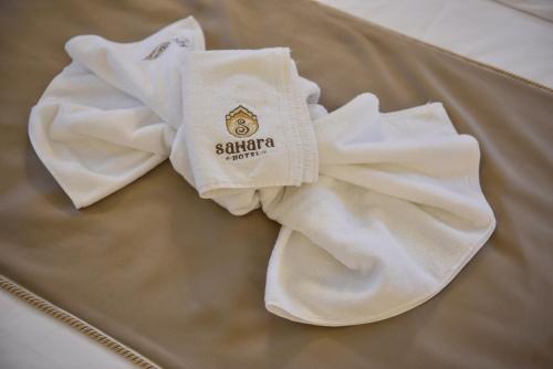 two white towels sitting on top of a table at Sahara Hotel in Svilengrad