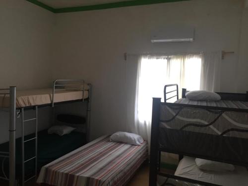 a room with two bunk beds and a window at Hostal La Concordia in Ciudad Valles