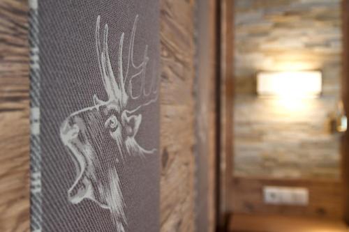 a wall with a drawing of a deer on it at Alpenchalet Brücke in Mayrhofen