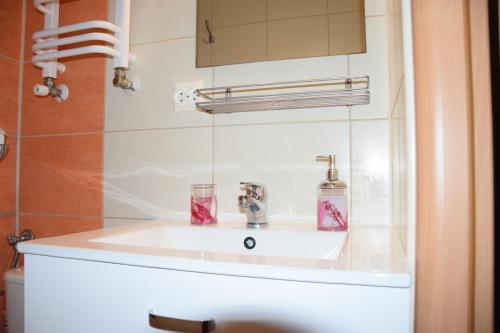 a white sink in a bathroom with a mirror at Willa Bea in Gdańsk