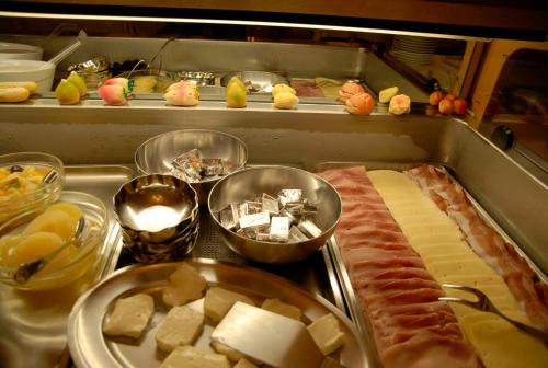 a buffet with meats and cheese and other food items at Albergo Adele in Bormio