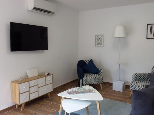 a living room with a tv and a couch and a table at Esmeralda Apartment in Albir