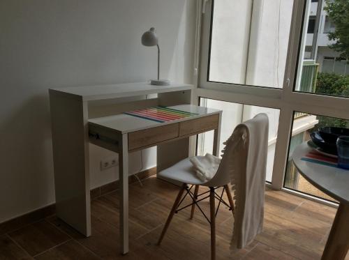 a desk with a chair next to a window at Esmeralda Apartment in Albir