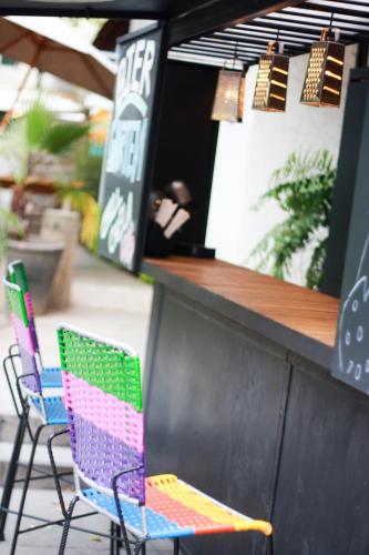 a couple of chairs sitting in front of a bar at Hostel Hospedarte Chapultepec in Guadalajara