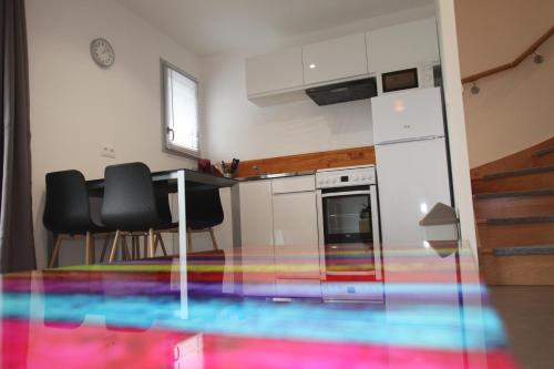a kitchen with a rainbow floor in a room at Résidence Beauvoir le Mont-Saint-Michel (9 gîtes de 2 à 5 personnes) in Beauvoir