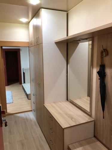 a dressing room with a mirror and a closet at Apartment Sever Hroncova in Košice