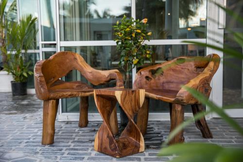 a wooden bench with a vase of flowers on it at Numero Uno Beach House in San Juan