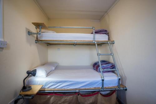a small room with two bunk beds in it at Anglesey Outdoors in Holyhead