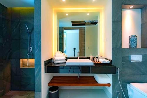 a bathroom with a sink and a mirror at Patong Heights in Patong Beach