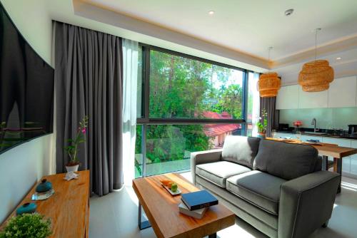 a living room with a couch and a table at Patong Heights in Patong Beach