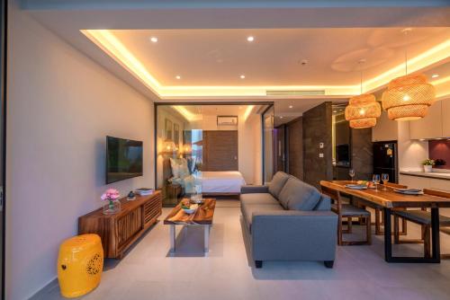 a living room with a couch and a dining room at Patong Heights in Patong Beach