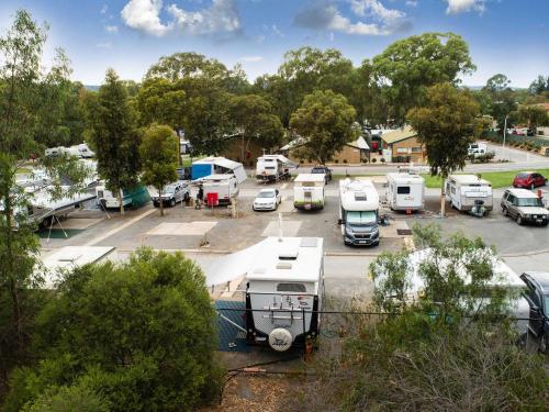 a parking lot with a bunch of parked vehicles at Windsor Gardens Caravan Park in Adelaide