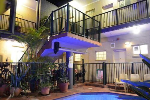 a swimming pool with a staircase in a building at Newtown Backpackers in Sydney