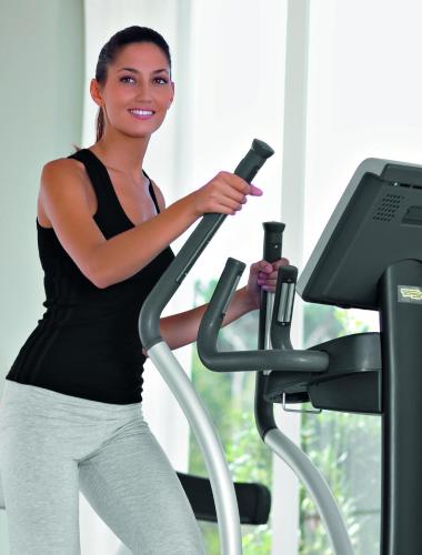 a woman running on a treadmill with a bottle at Hotel Agora Osaka Moriguchi in Osaka