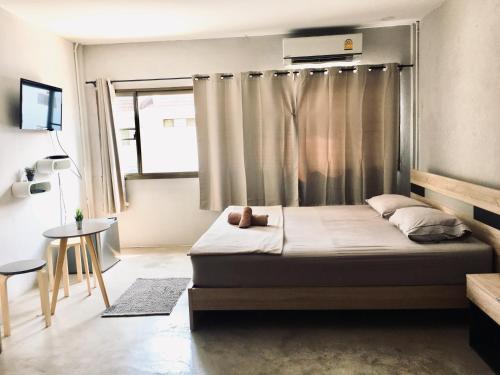 a small bedroom with a bed and a window at New Apartment Nearby Beach in Hua Hin