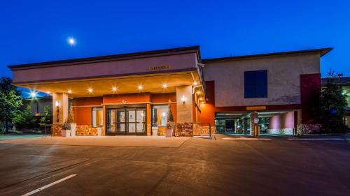 a man standing in front of a building at night at SureStay Hotel by Best Western Tehachapi in Tehachapi