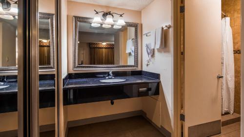 a bathroom with a sink and a mirror at SureStay Hotel by Best Western Tehachapi in Tehachapi