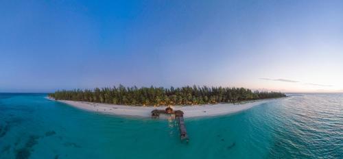 an island in the ocean with a person on it at Sutera at Mantanani Island Resort & Spa in Mantanani Island 