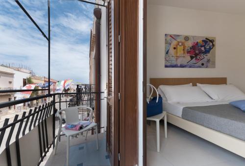 a bedroom with a bed on a balcony at B&B Adduari in San Vito lo Capo