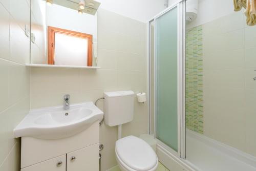 a bathroom with a toilet and a sink and a shower at Studio Apartments Stradun in Dubrovnik