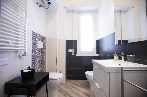 a bathroom with a white toilet and a sink at Dolce Vita Affittacamere in Rome
