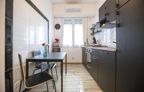 a small kitchen with a table and a table and chairs at Dolce Vita Affittacamere in Rome