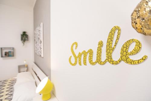 a bedroom with a smile sign on the wall at Dolce Vita Affittacamere in Rome
